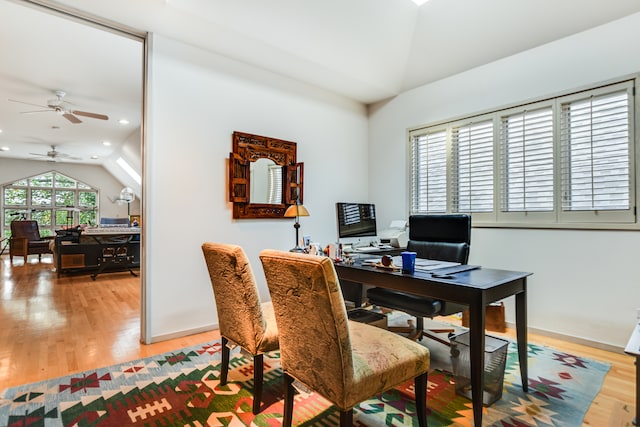 home office with light wood-type flooring, lofted ceiling, and ceiling fan