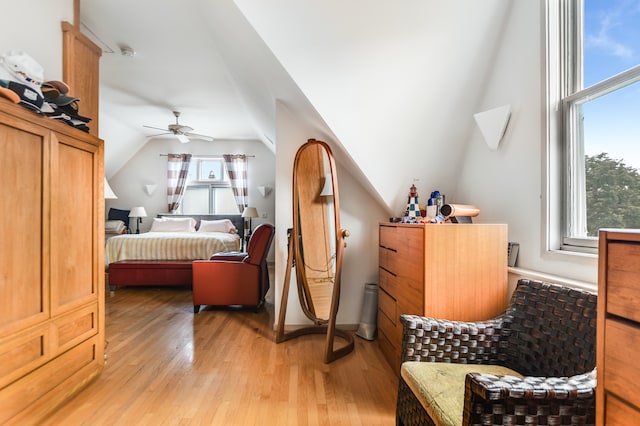 bedroom with light wood-type flooring, lofted ceiling, and ceiling fan