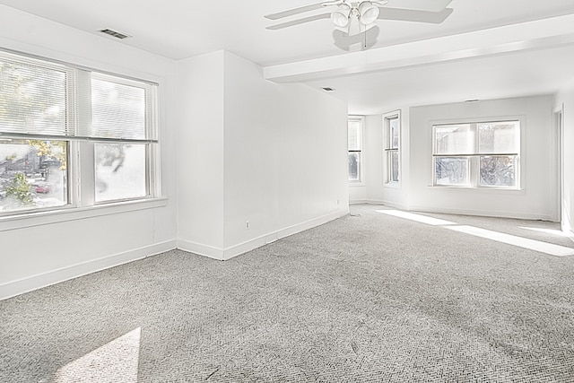 carpeted spare room featuring ceiling fan