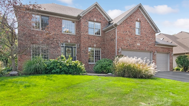 view of front facade featuring a front yard and a garage