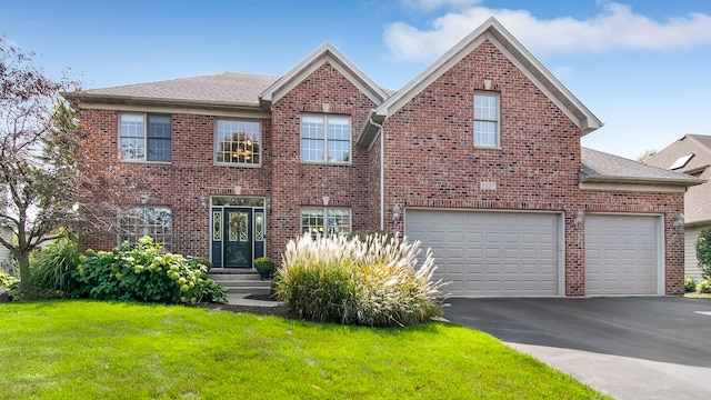 view of front of home featuring a front yard and a garage