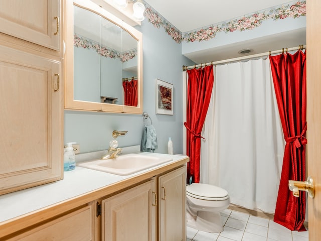 bathroom with tile patterned flooring, vanity, and toilet