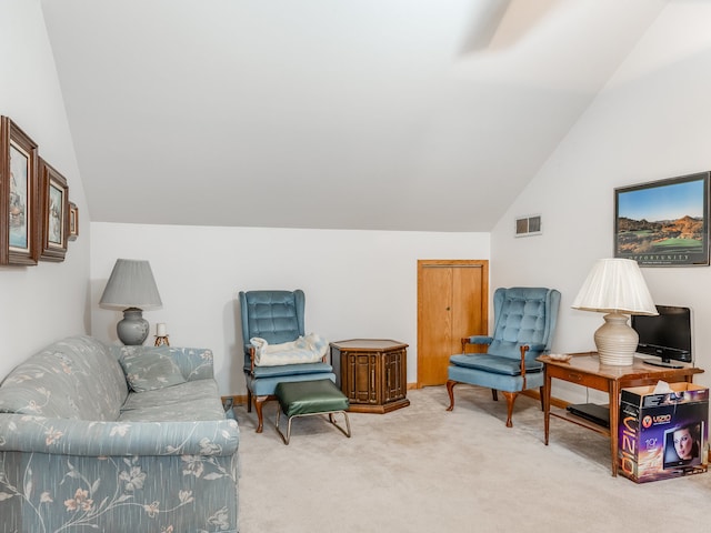 sitting room with vaulted ceiling and carpet