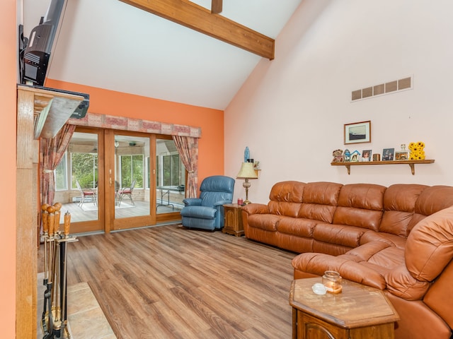 living room featuring high vaulted ceiling, light wood-type flooring, and beamed ceiling