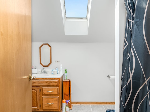 bathroom with a skylight and vanity