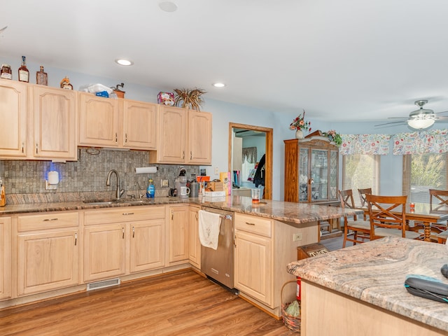 kitchen featuring kitchen peninsula, dishwasher, light wood-type flooring, ceiling fan, and sink