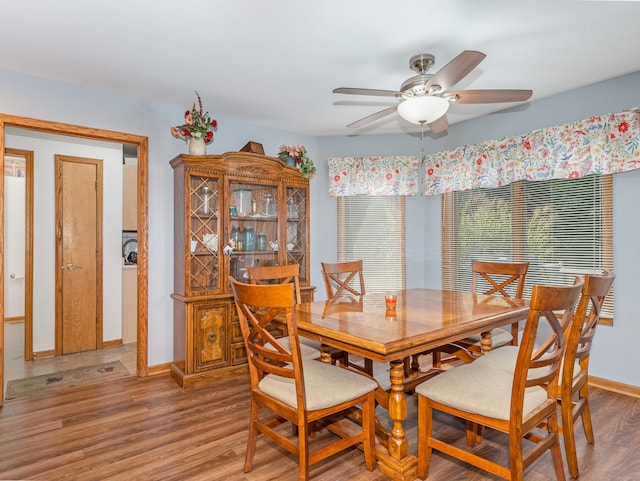 dining area featuring wood-type flooring and ceiling fan