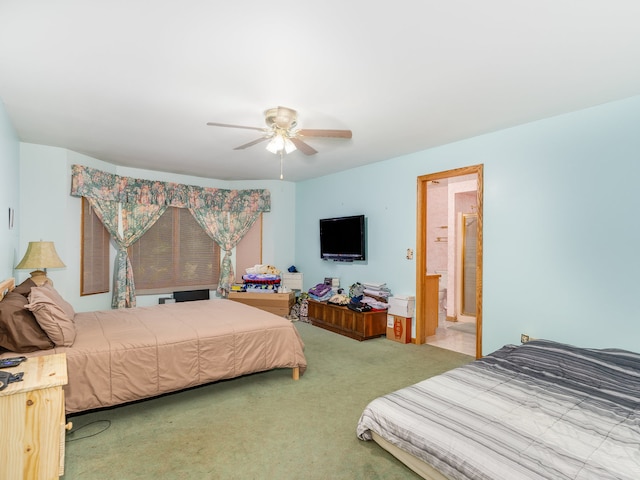 bedroom featuring ceiling fan, connected bathroom, and carpet