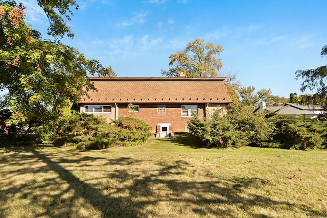 back of property featuring a lawn