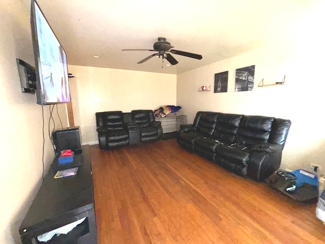 living room featuring ceiling fan and hardwood / wood-style flooring