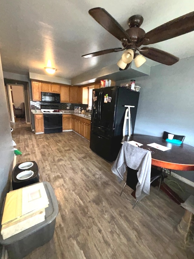 interior space with ceiling fan, vaulted ceiling, and dark hardwood / wood-style flooring