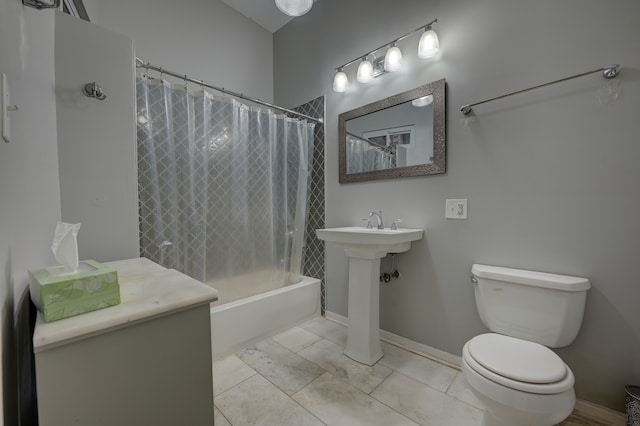 bathroom featuring shower / bath combo with shower curtain, tile patterned floors, and toilet