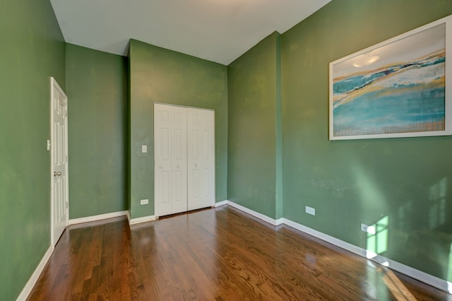 unfurnished bedroom featuring a closet and hardwood / wood-style floors