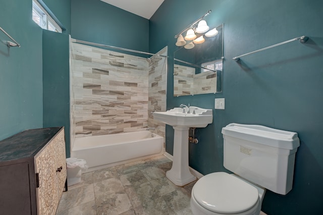 bathroom with tiled shower / bath combo and toilet