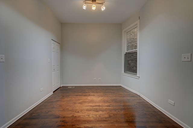 spare room with dark hardwood / wood-style flooring