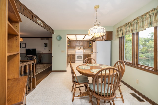 dining area with an inviting chandelier and crown molding