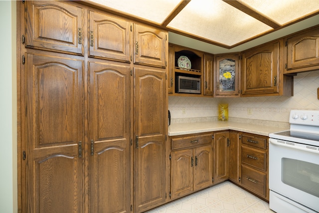 kitchen featuring tasteful backsplash and white range with electric cooktop