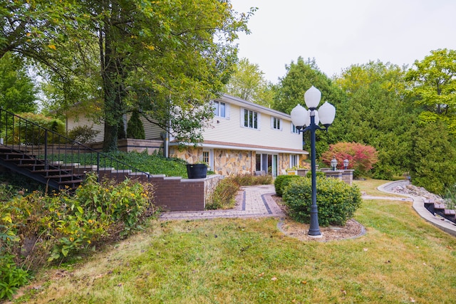 view of front facade with a patio and a front lawn