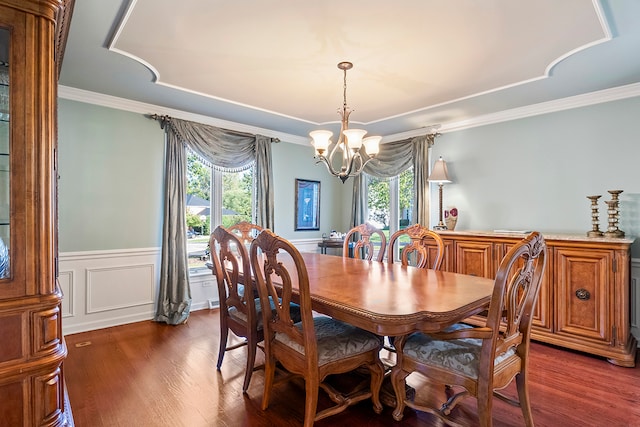 dining space with a chandelier, dark hardwood / wood-style floors, plenty of natural light, and crown molding