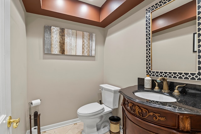 bathroom featuring tile patterned flooring, vanity, and toilet