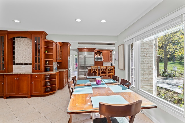 dining room featuring sink and light tile patterned floors