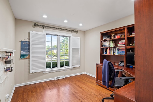 office area with light hardwood / wood-style floors