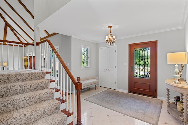 foyer entrance featuring crown molding and a notable chandelier