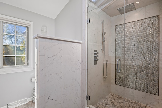 bathroom with vaulted ceiling and an enclosed shower