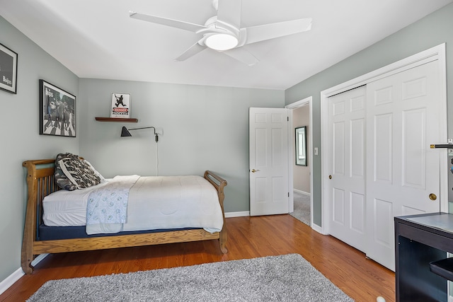 bedroom featuring ceiling fan, hardwood / wood-style flooring, and a closet