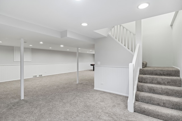 basement featuring light carpet