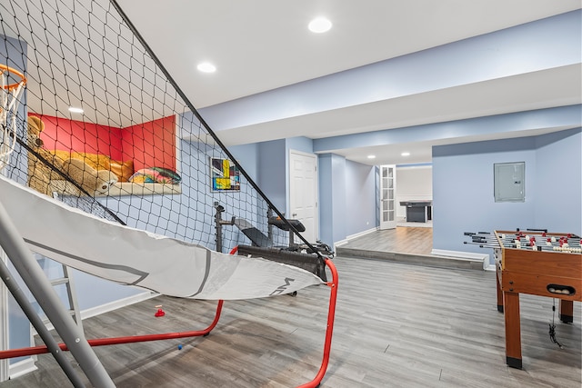 game room with hardwood / wood-style flooring and electric panel