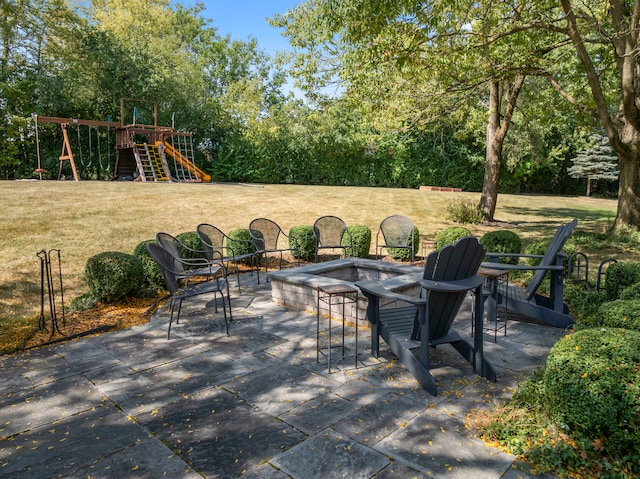 view of patio / terrace with a playground and an outdoor fire pit