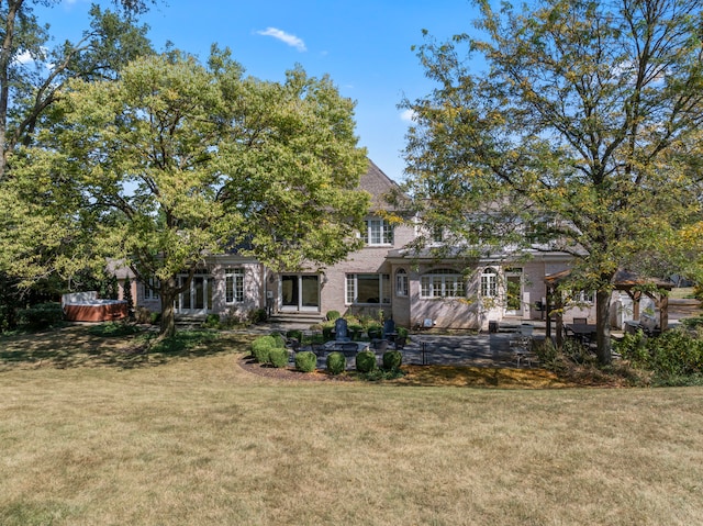 back of house featuring a lawn