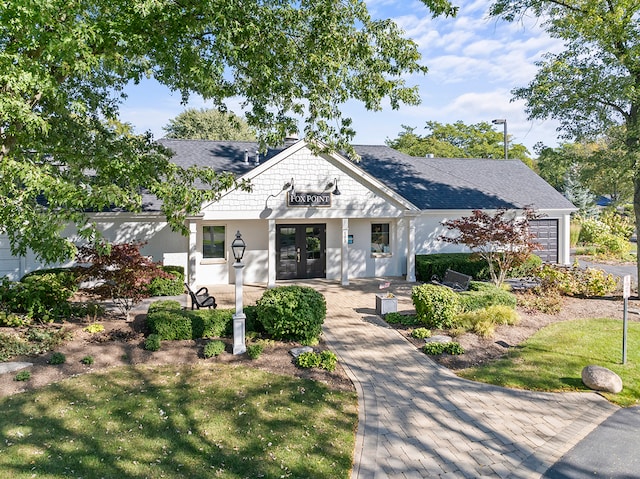 view of front facade featuring french doors and a front lawn