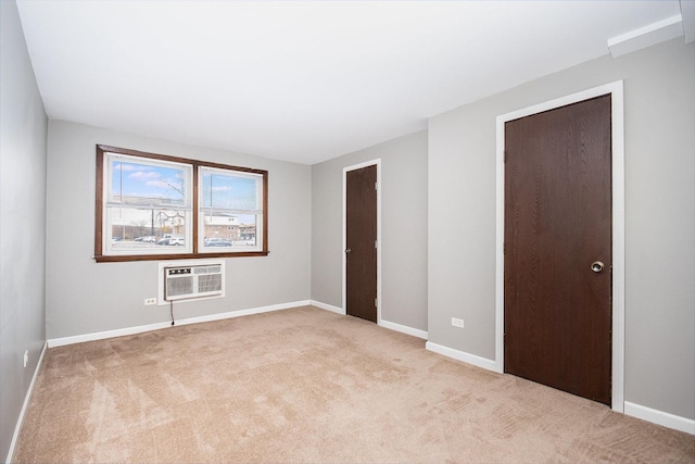 carpeted spare room featuring a wall mounted AC