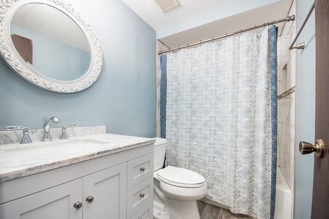 full bathroom featuring hardwood / wood-style flooring, vanity, toilet, and shower / bath combo