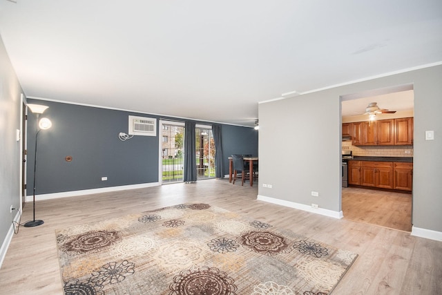 unfurnished living room featuring a wall mounted AC, ceiling fan, light hardwood / wood-style floors, and ornamental molding