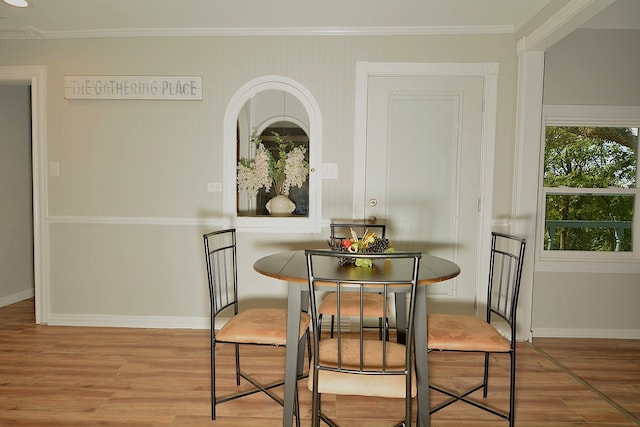 dining room featuring wood-type flooring and ornamental molding