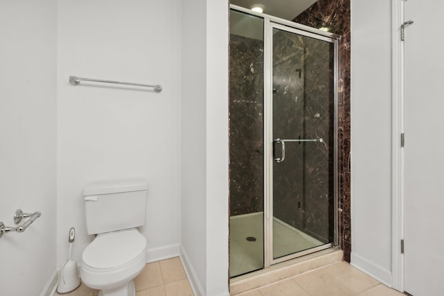 bathroom with walk in shower, tile patterned floors, and toilet