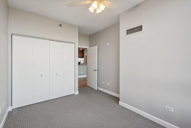 unfurnished bedroom featuring a closet, ceiling fan, and carpet flooring