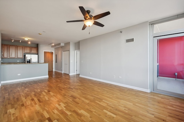 unfurnished living room featuring light hardwood / wood-style floors and ceiling fan