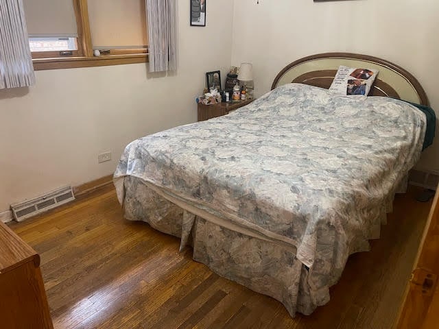 bedroom featuring dark wood-type flooring