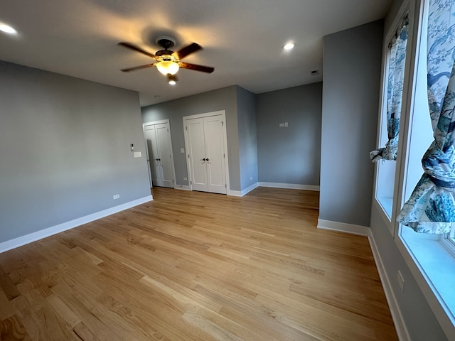 spare room featuring ceiling fan and light hardwood / wood-style floors