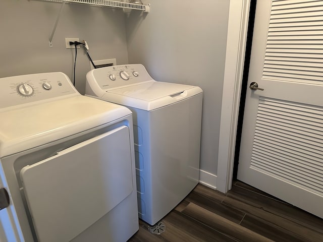 laundry room featuring washing machine and dryer and dark wood-type flooring