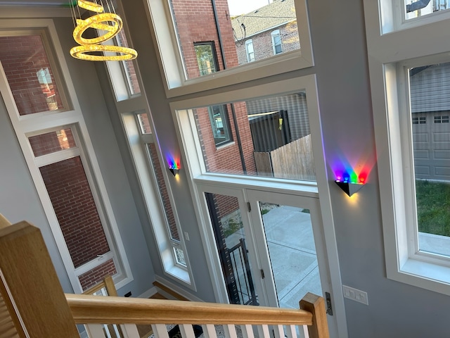 foyer with a high ceiling and an inviting chandelier