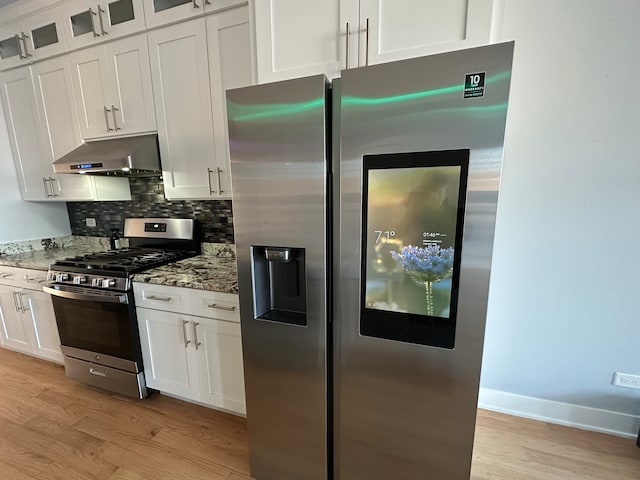 kitchen featuring white cabinets, light stone counters, and appliances with stainless steel finishes