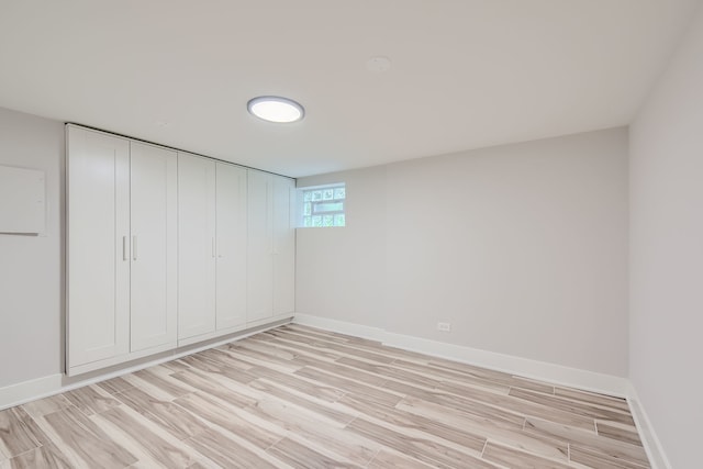 unfurnished bedroom featuring a closet and light hardwood / wood-style floors