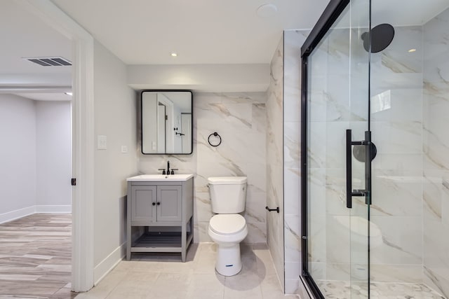 bathroom with walk in shower, tile walls, vanity, and toilet