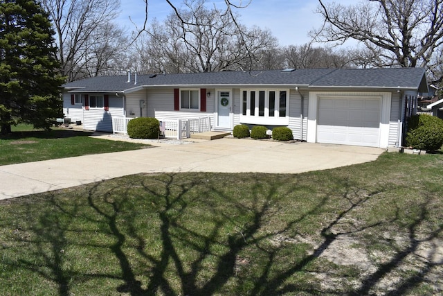 ranch-style house with an attached garage, roof with shingles, driveway, and a front lawn