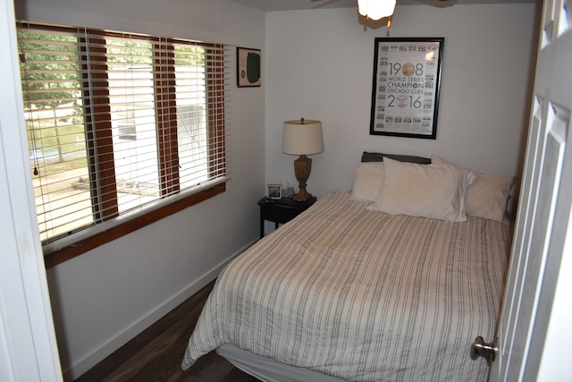 bedroom with dark hardwood / wood-style flooring and ceiling fan